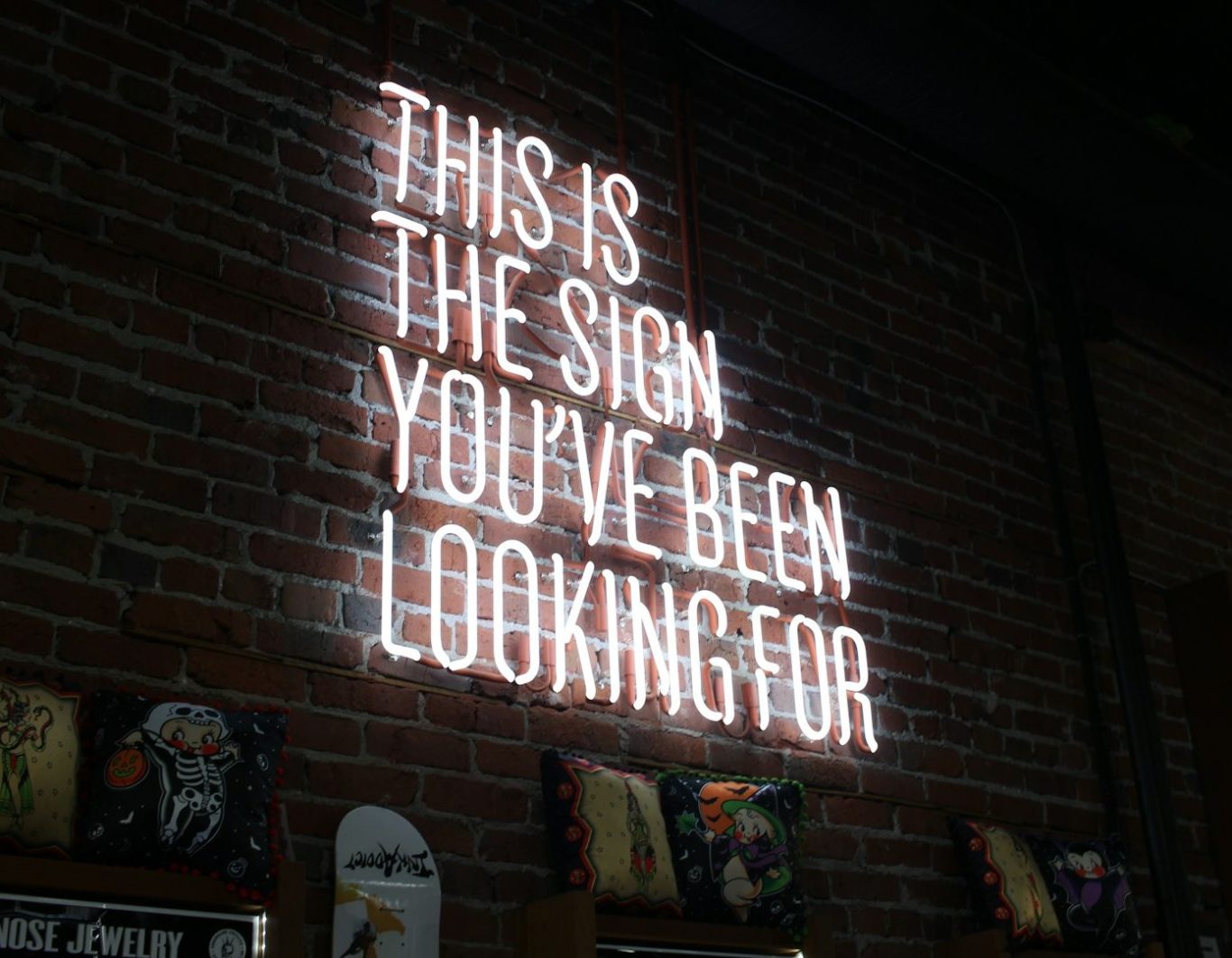 Neon sign on a brick wall that reads, "This is the sign you've been looking for."