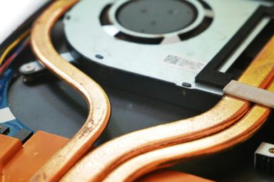 overheating fans Close-up of copper heat pipes and components in a cooling system.
